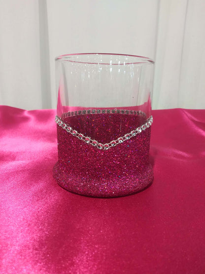 An elegant Fushia blinged highball glass with the phrase I Only Have Taste for Whiskey-Halloween Blinged Whiskey-Highball Glasses printed on it and decorated with glitter along the base, displayed on a pink surface.