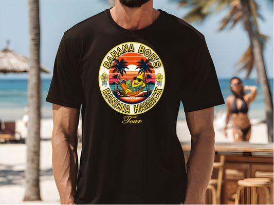 A Man wearing a black t-shirt with a colorful graphic Banana Bob's Banana Hamack Tour design on a beach.