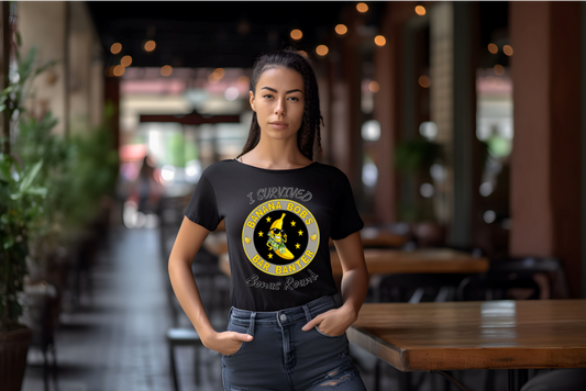Woman wearing a black t-shirt with a yellow graphic I Survived Banana Bob's Bar Banter Bonus Round design in an outdoor setting.